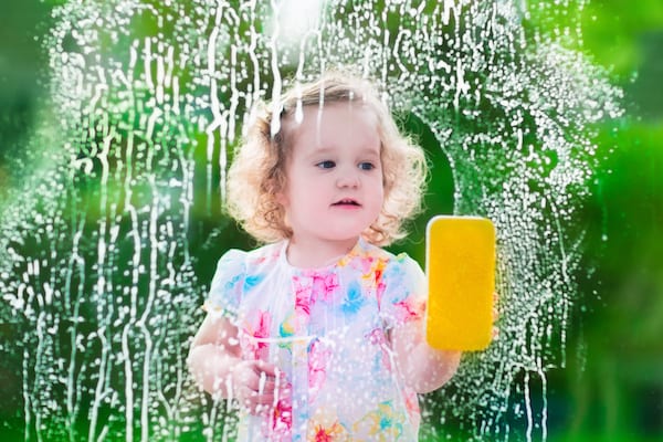 Child cleaning window with safe cleaning product